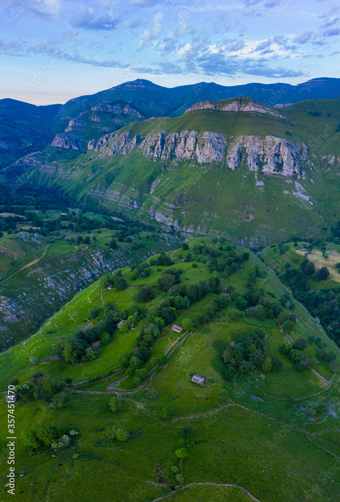 Spring landscape of mountains, meadows of mowing and cabins pasiegas in the Valle del Miera, Cantabria, Spain, Europe