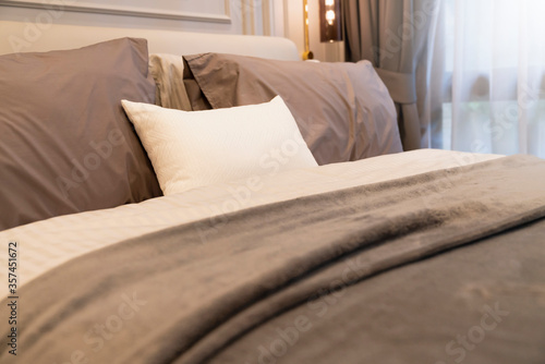 close up white beige soft pillows on bed and blanket bedroom interior design concept.bed maid luxury ideas concept