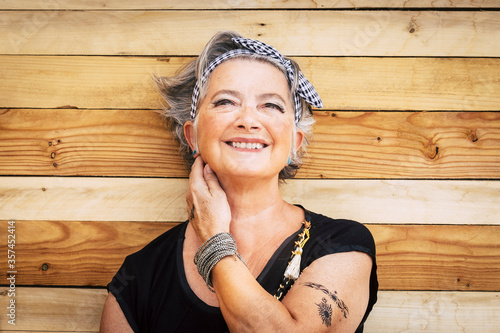Принти на полотні Portrait of cheerful caucasian senior happy woman with wood background - alterna