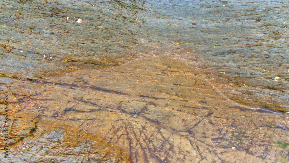 Fototapeta premium Rocks, pebbles, rock pools, sandsand ocean on an overcast June day in Cornwall