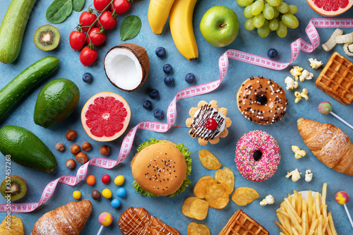 Photography Healthy and unhealthy food background from fruits and vegetables vs fast food, sweets and pastry top view