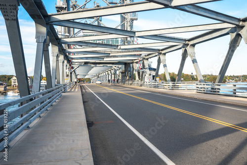 Steel vertical ift bridge with walkways on both sides of the road on a clear autumn day. Portsmouth, NH, USA. © alpegor