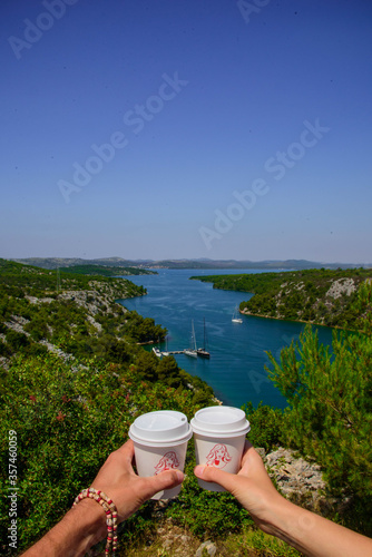 Two white cup with coffee over the bay