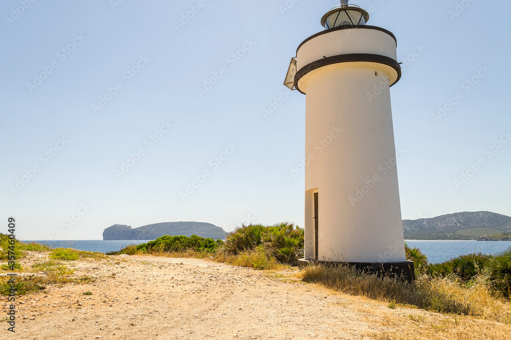 Lighthouse and in the background Capo Caccia (Alghero, Sardinia, Italy).