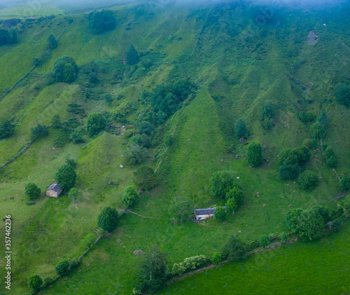 Spring landscape of mountains, meadows of mowing and cabins pasiegas near La Concha, in the Valle del Miera, Cantabria, Spain, Europe