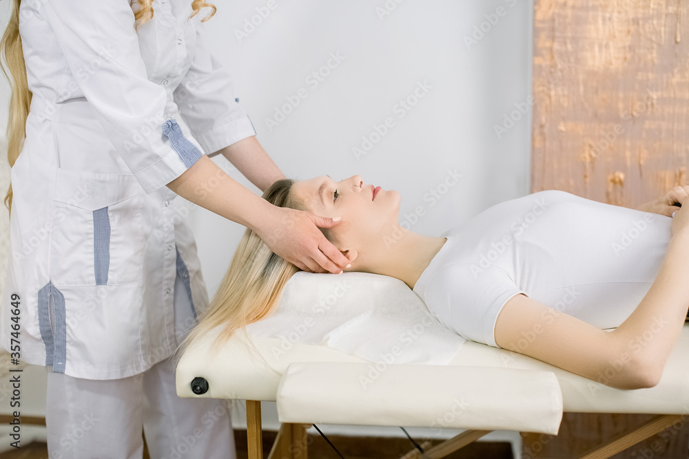 Spa and cosmetology concept. Cropped image of woman cosmetologist examining patient face and hair of young pretty Caucasian woman patient, in medical esthetic beauty office. Spa and cosmetology concept. Cropped image of woman cosmetologist examining patient face and hair of young pretty Caucasian woman patient, in medical esthetic beauty office.