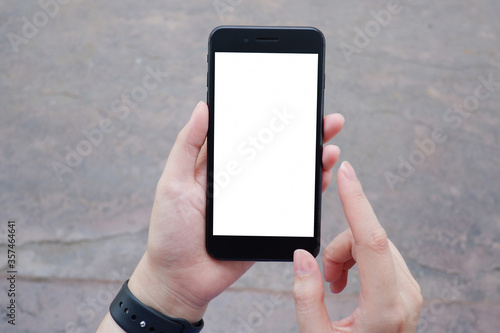 Cropped shot view of business woman’s hands holding the mobile phone with blank copy space screen for your information content or text message.