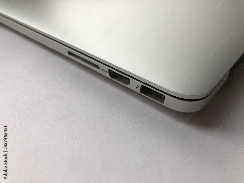 Side view on ports of the silver laptop. Side view on ports of the silver laptop.