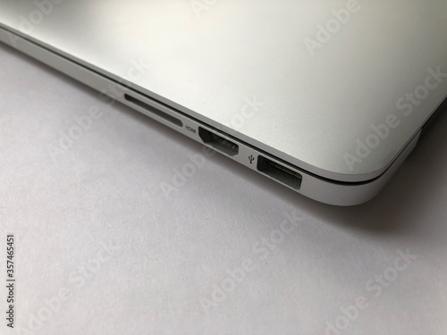Side view on ports of the silver laptop.