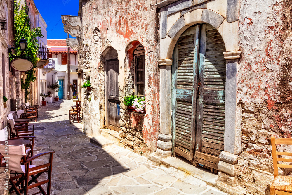 Traditional Greece. Typical street cafe bars. Halki village.  Naxos island, Cycades. - obrazy, fototapety, plakaty 