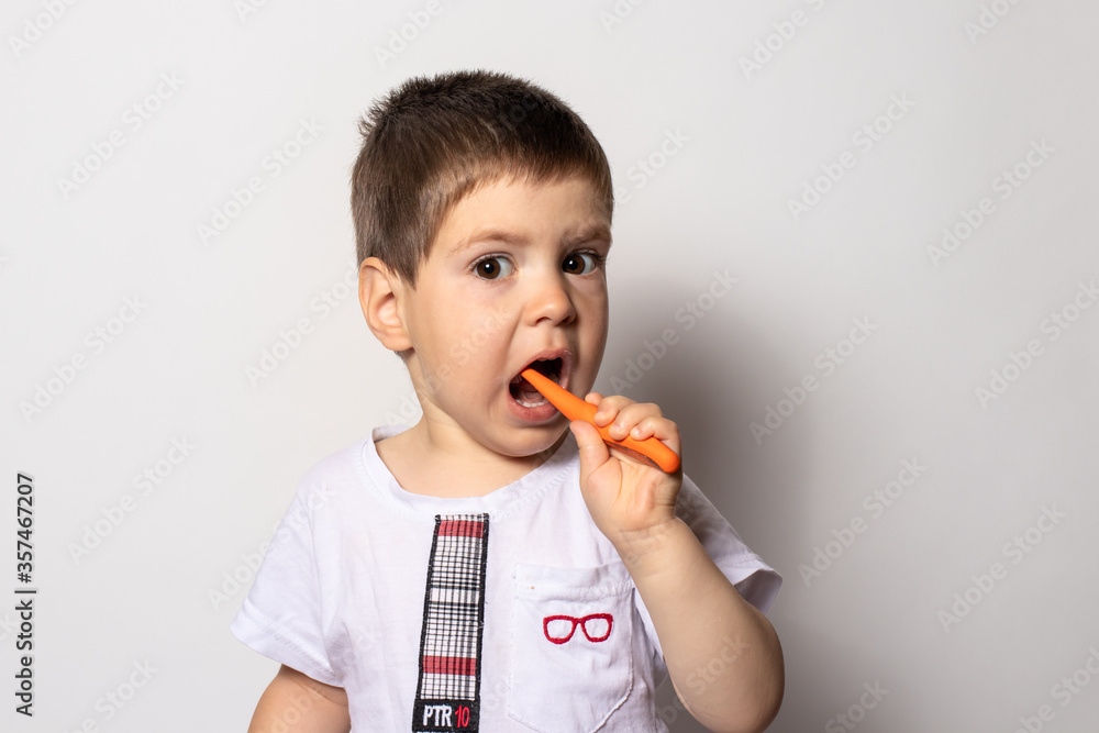 Little boy brushes his teeth with baby toothpaste. Children's toothbrush. Little boy brushes his teeth with baby toothpaste. Children's toothbrush.