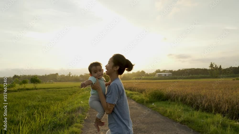happy mother and baby playing together outdoor enjoy beautiful sunset in the field happy mother and baby playing together outdoor enjoy beautiful sunset in the field