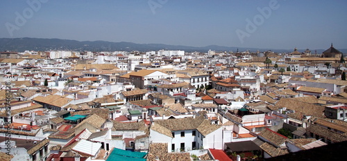 Bright morning over historical cityscape of Cordoba with houses and tile roofs, Spain.