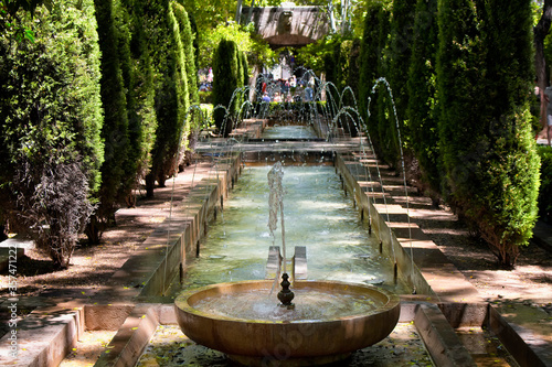 View of water fountain and trees at Hort del Rei park photo