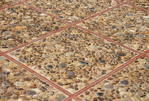 Close up view of old, historicial floor tiles made of stones photo