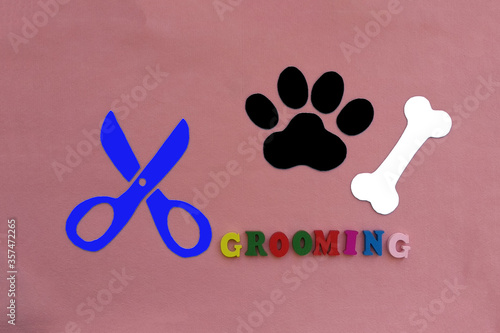 Bone, paw print, scissors on a pink background. Haircut of Pets.