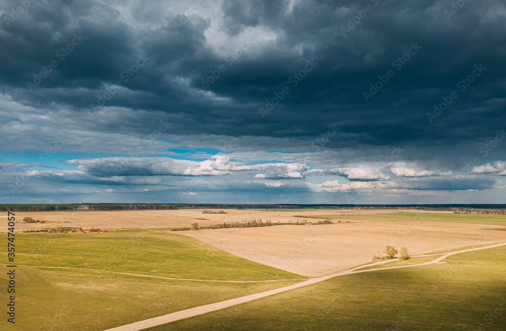 Aerial View. Amazing Natural Dramatic Sky With Rain Clouds Above Countryside Rural Field Landscape In Spring Day. Scenic Sky With Fluffy Clouds On Horizon. Beauty In Nature