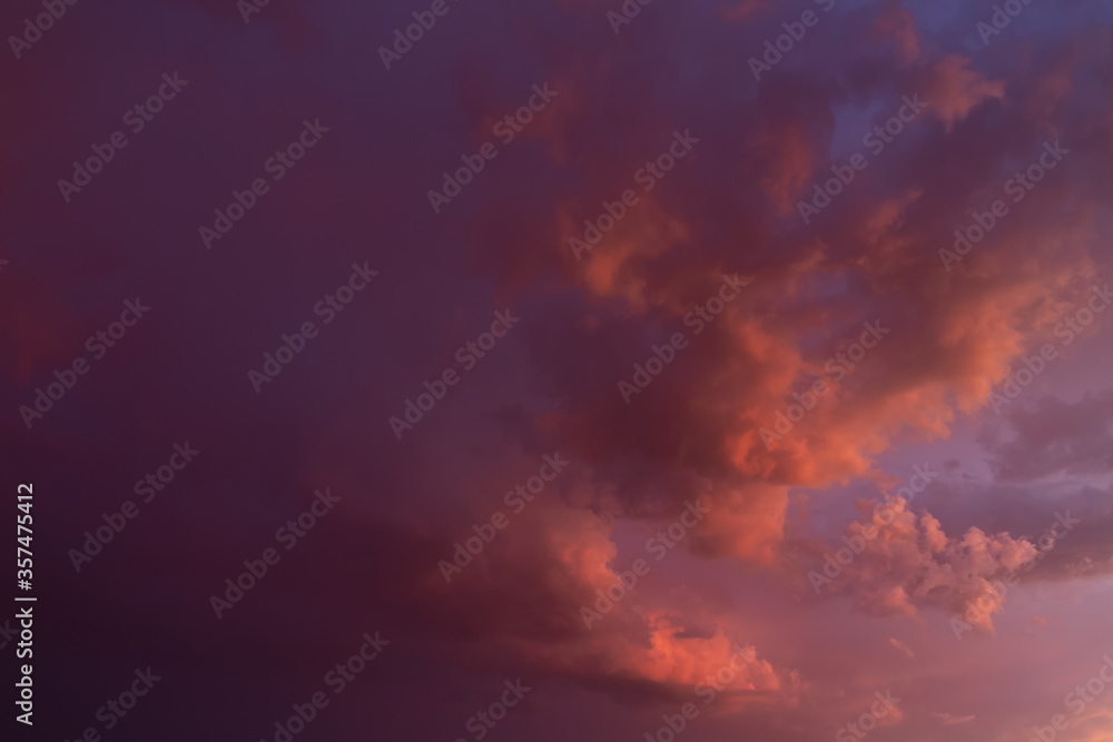 The unusual and beautiful pink and purple sunset sky. Sky background. Storm clouds at sunset.
