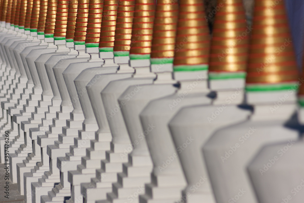 Fototapeta premium Close up of row of buddhist stupas painted in white.