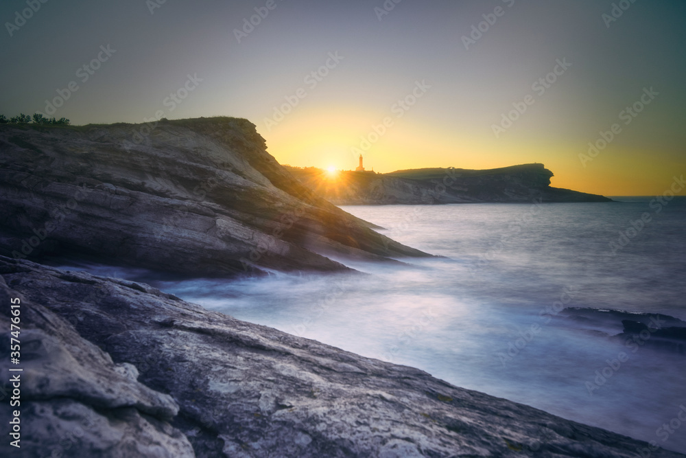 Obraz premium Sunset sky over sea and cliffs