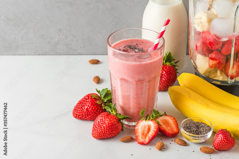 © samael334 - Glass of strawberry and banana vegan smoothie or milkshake made of almond milk with fresh juicy ingredients in blender