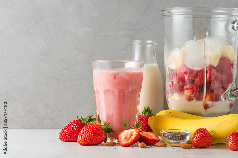 Glass strawberry and banana smoothie or milkshake fresh juicy ingredients in blender for drink Stock Photo Adobe Stock