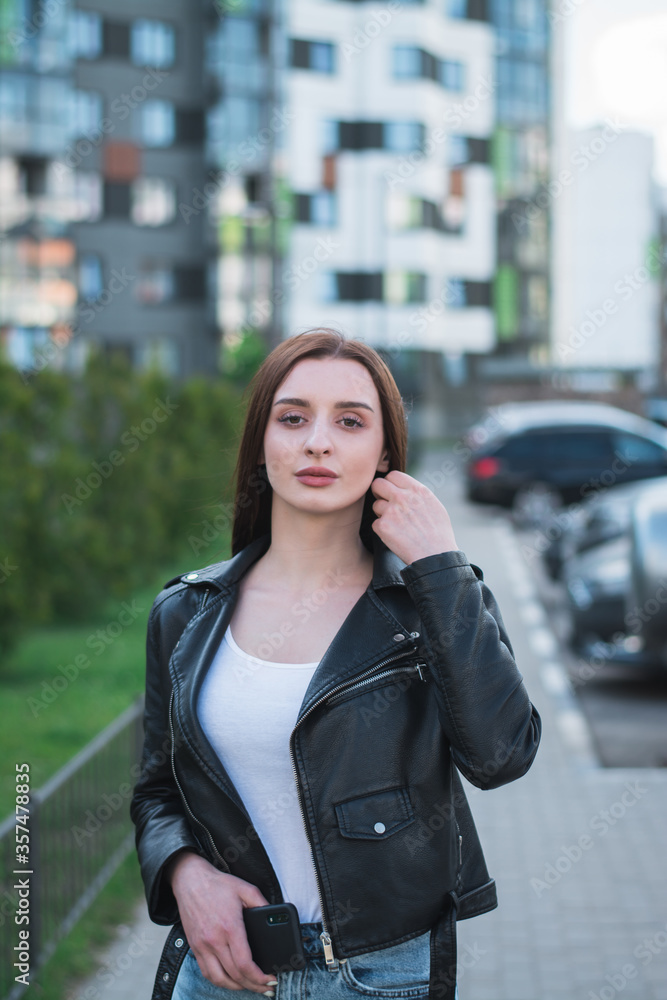 beautiful stylish young girl in a black leather jacket on the streets beautiful stylish young girl in a black leather jacket on the streets