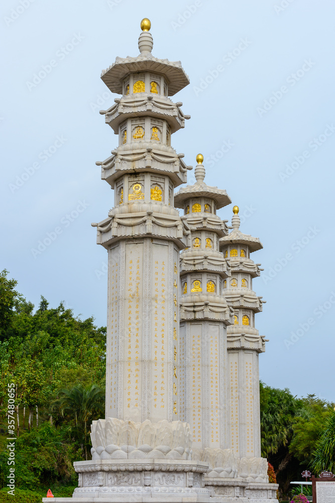 Buddhist stone pillars (prayer flags columns) on the territory of Buddhist center Nanshan on a cloudy day. Buddhist stone pillars (prayer flags columns) on the territory of Buddhist center Nanshan on a cloudy day.