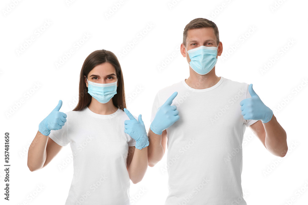 Volunteers in masks and gloves on white background. Protective measures during coronavirus quarantine Volunteers in masks and gloves on white background. Protective measures during coronavirus quarantine