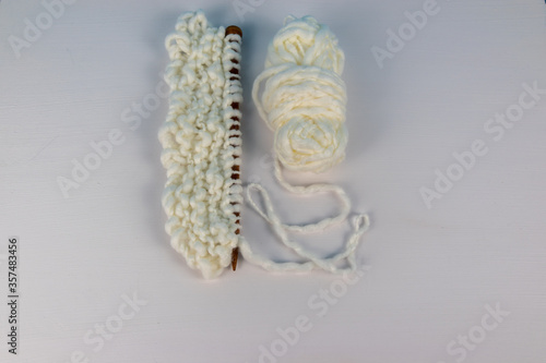 white knitting wool and needles 