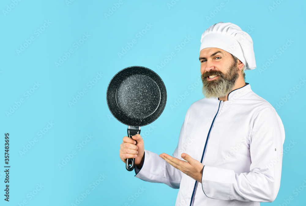 Teflon might be toxic. Nonstick pan for frying. Enameled cooking vessels. Man hold pan. Frying meal. Healthy food. Bearded chef preparing breakfast. Frying without oil. Professional kitchenware Teflon might be toxic. Nonstick pan for frying. Enameled cooking vessels. Man hold pan. Frying meal. Healthy food. Bearded chef preparing breakfast. Frying without oil. Professional kitchenware