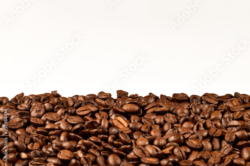 Roasted coffee beans isolated on white background. Border coffee bean decorated with blank copy space for your message.