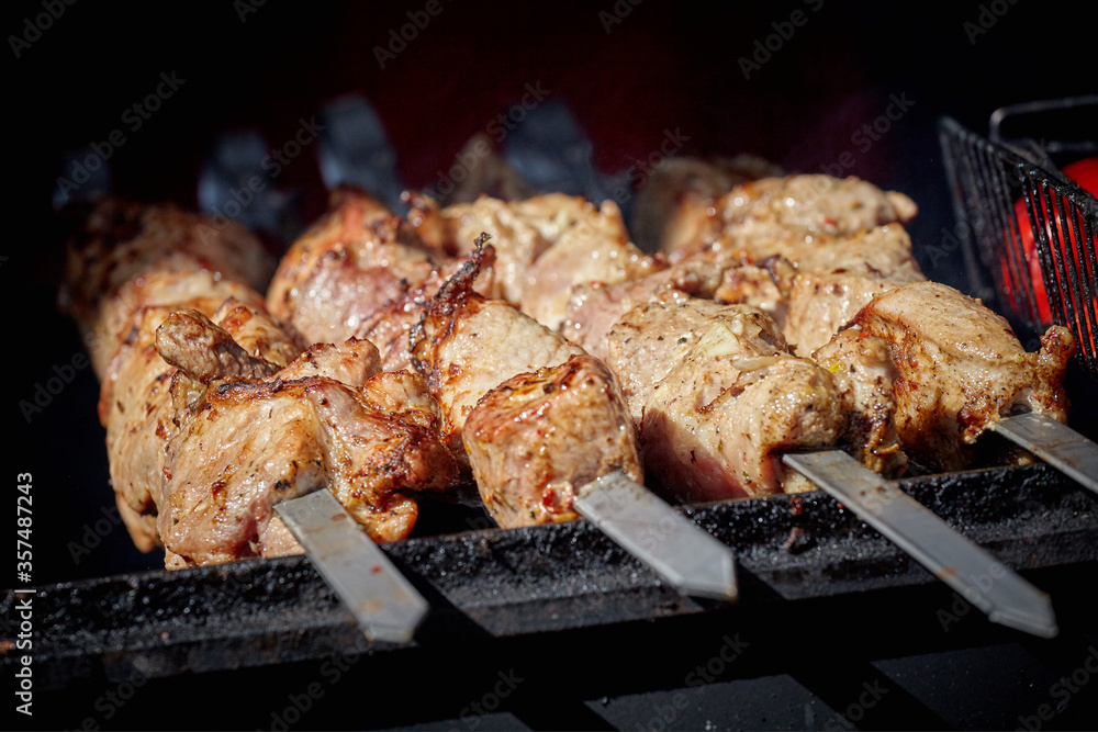 Skewers with meat on the barbecue grill