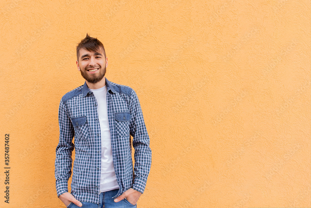 beautiful and happy man against the orange wall beautiful and happy man against the orange wall