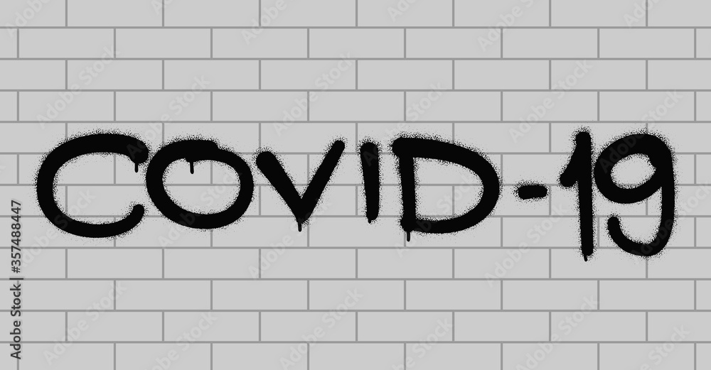 Spray graffiti inscription COVID-19 on white brick wall. New official name for Coronavirus. A warning message against spreading disease. Spray graffiti inscription COVID-19 on white brick wall. New official name for Coronavirus. A warning message against spreading disease.