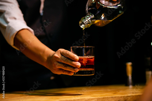 Barman pouring whiskey whiskey glass beautiful night