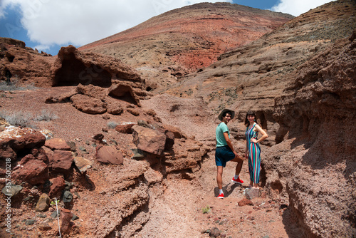 Young cheerful couple exploring a volcanic landscape during summer holiday