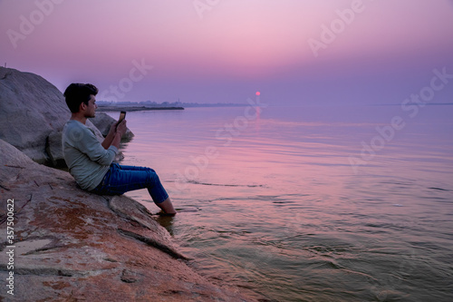 Man Seeing at Ganga river at evening sunset