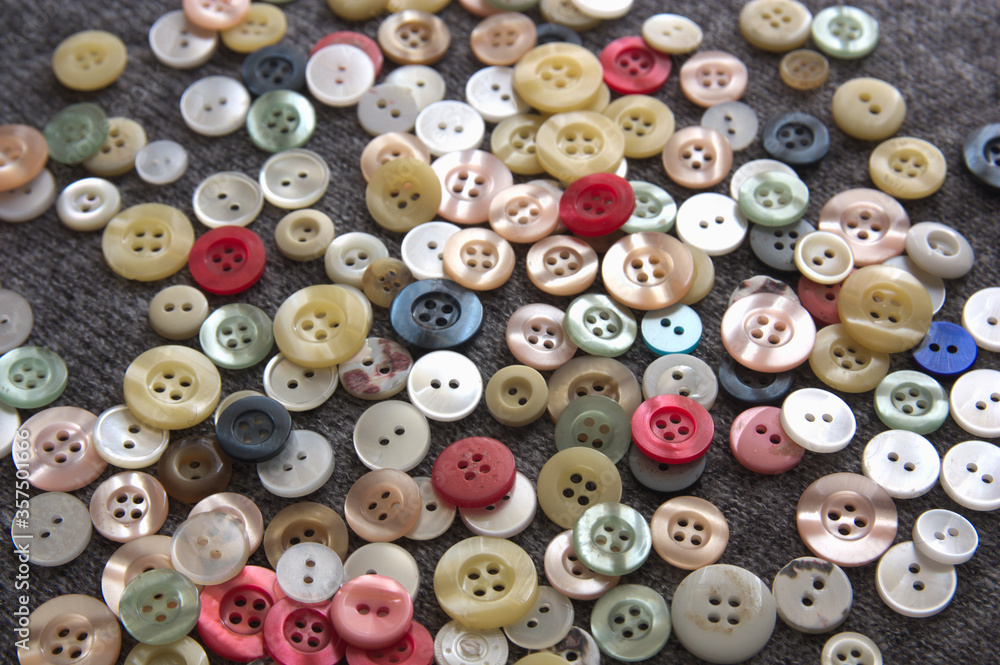 Close-up of a bunch of buttons scattered covering the image background Close-up of a bunch of buttons scattered covering the image background
