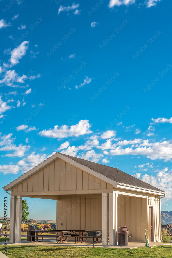 Building with attached picnic pavilion at a park against mountain and blue sky Building with attached picnic pavilion at a park against mountain and blue sky