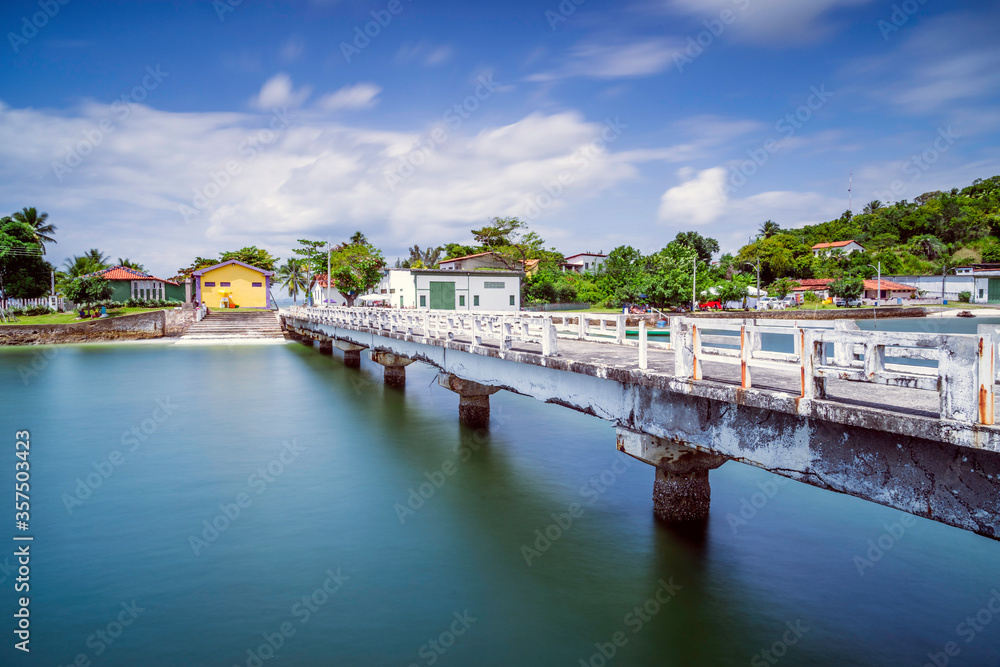 Fototapeta premium pier on the shore of the beach with the full tide