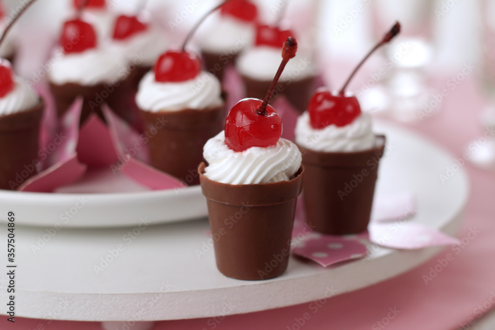 chocolate cups with cream and cherry chocolate cups with cream and cherry