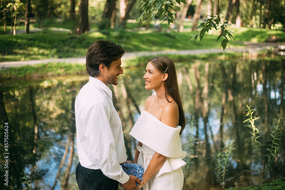 Happy Wedding Couple Saying Vows Holding Hands Standing In Park Happy Wedding Couple Saying Vows Holding Hands Standing In Park