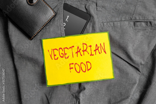 Conceptual hand writing showing Vegetarian Food. Concept meaning refers to the cuisine that fulfills a vegan s is conditions Smartphone device inside trousers front pocket with wallet photo