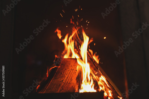 Fireplace with burning wood  closeup view. Winter vacation