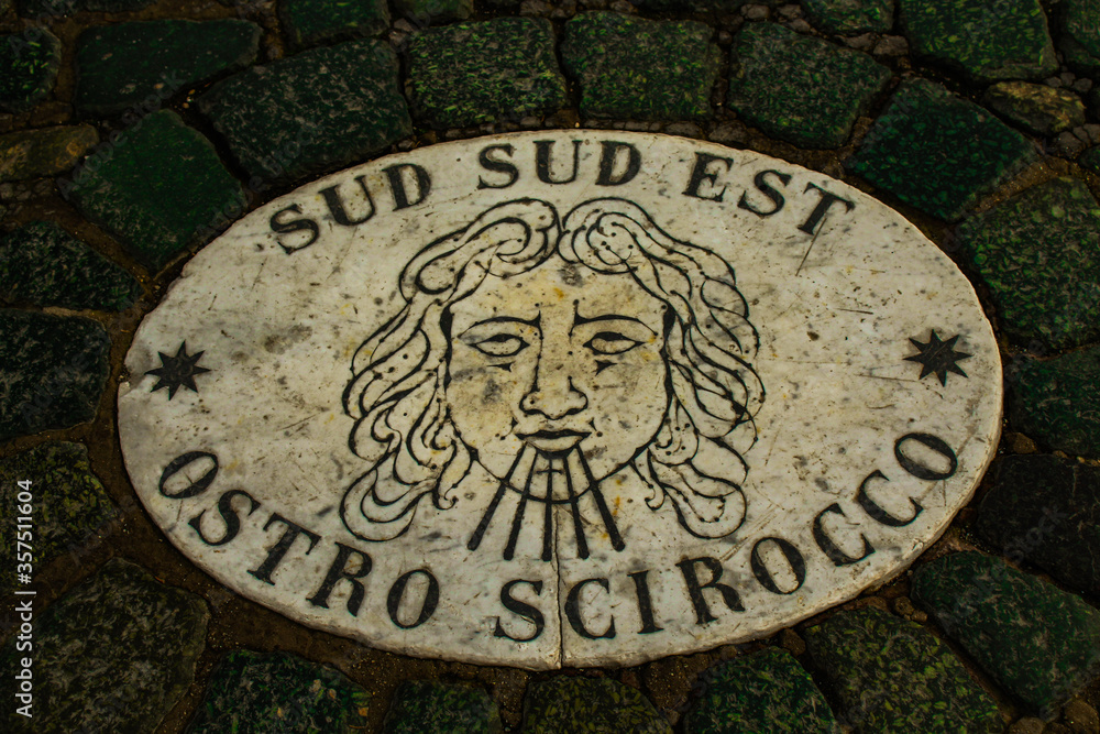 The marble symbol with the direction of the wind on the St. Peter's Square pavement, Vatican. The marble symbol with the direction of the wind on the St. Peter's Square pavement, Vatican.