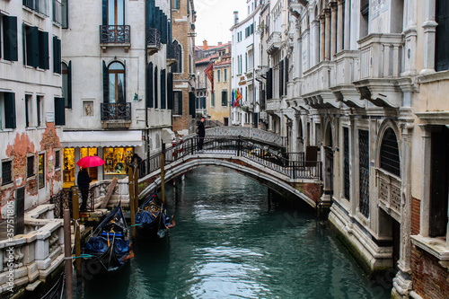 Narrow canal with gondolas and bridge in Venice. Picturesque old town, Italy. © An Instant of Time