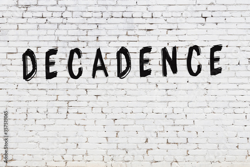 Fotografie Word decadence painted on white brick wall