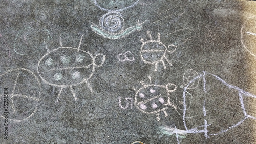 Children chalk paintings on the pave way in kindergarten