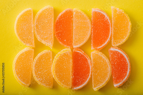 Multi-colored marmalade jelly candy's. Dessert marmalade in the form of lemon and orange slices. The sweetness of jelly candy yellow and orange. Top view